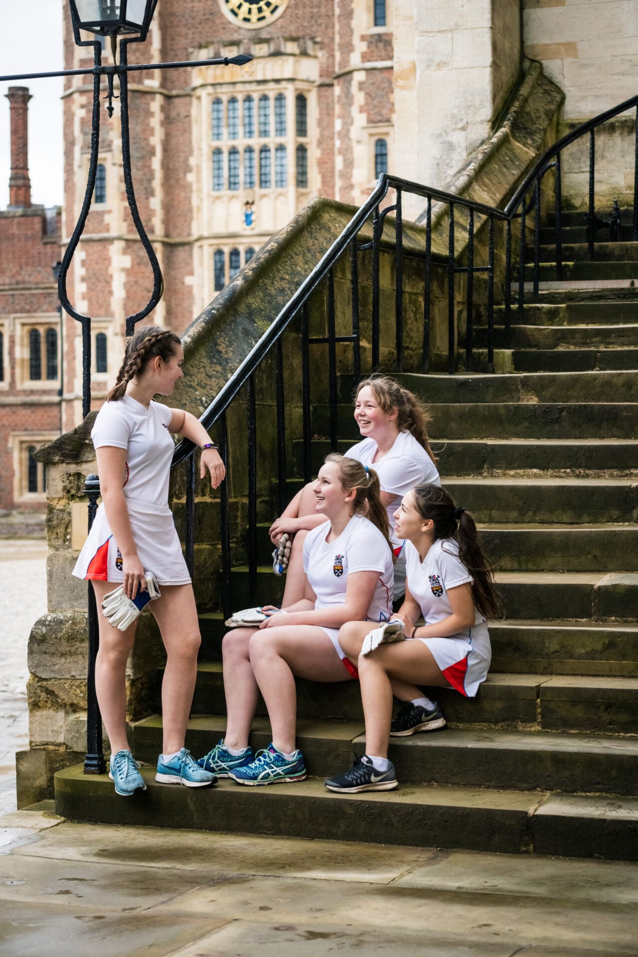 Image of girls sat on steps at Eton College