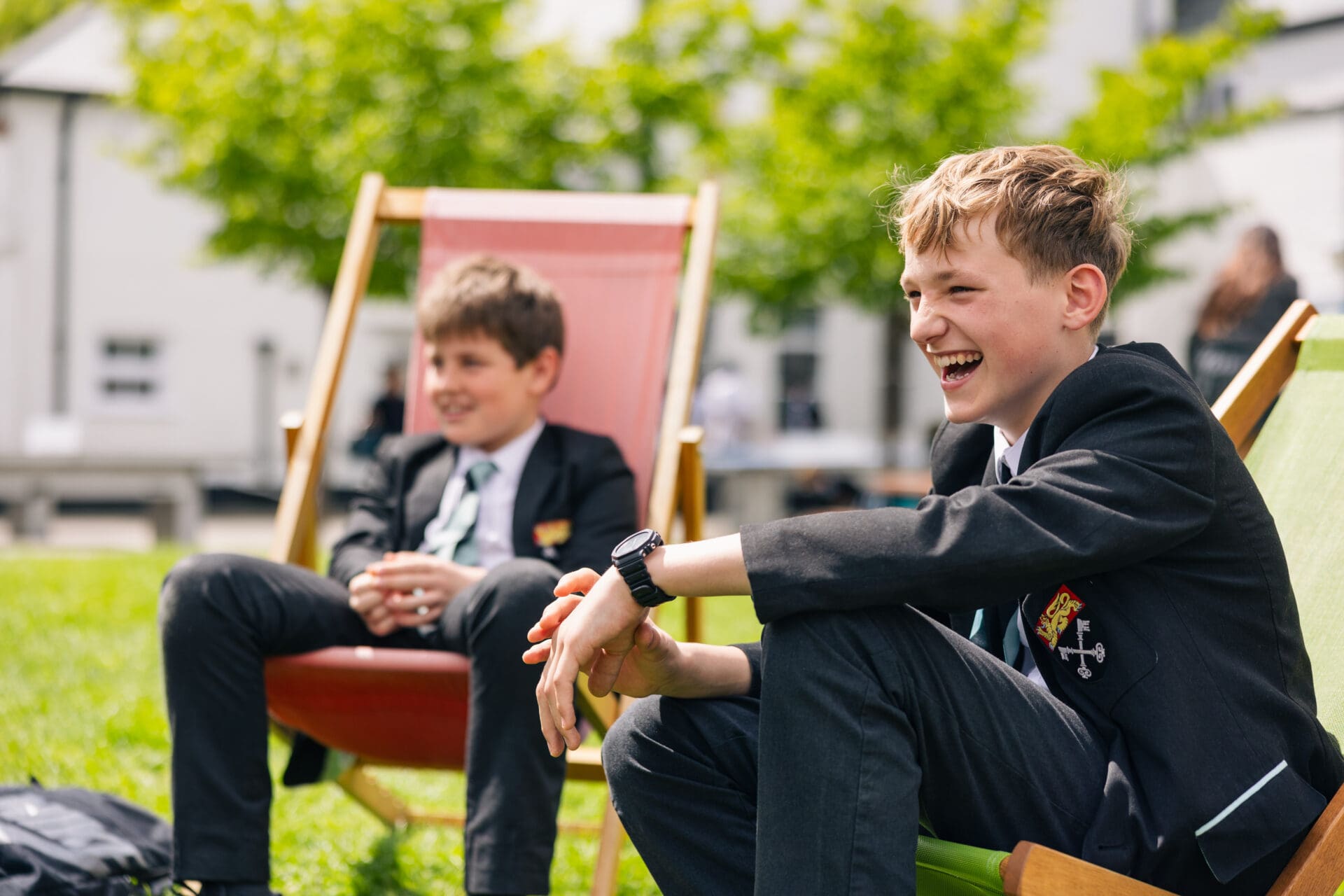 Image of 2 male pupils sat on deckchairs in the quad