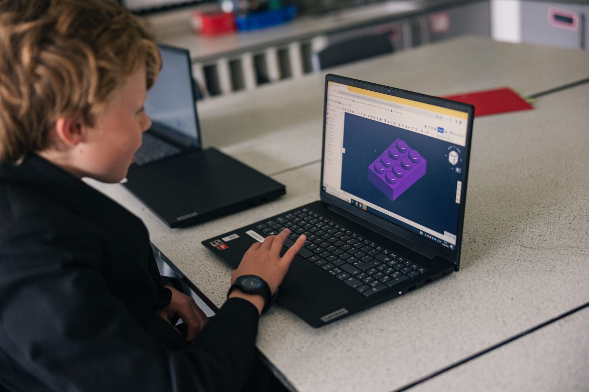 Image of a pupil creating art on a computer