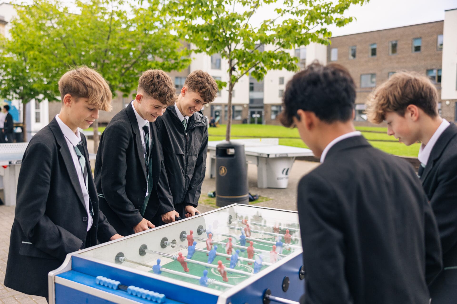 Image of 5 pupils playing table football