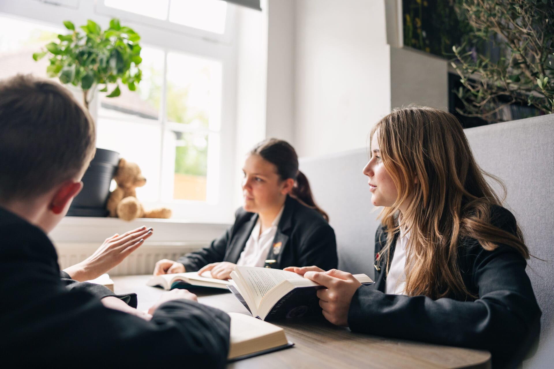 Image of pupils reading at a table together