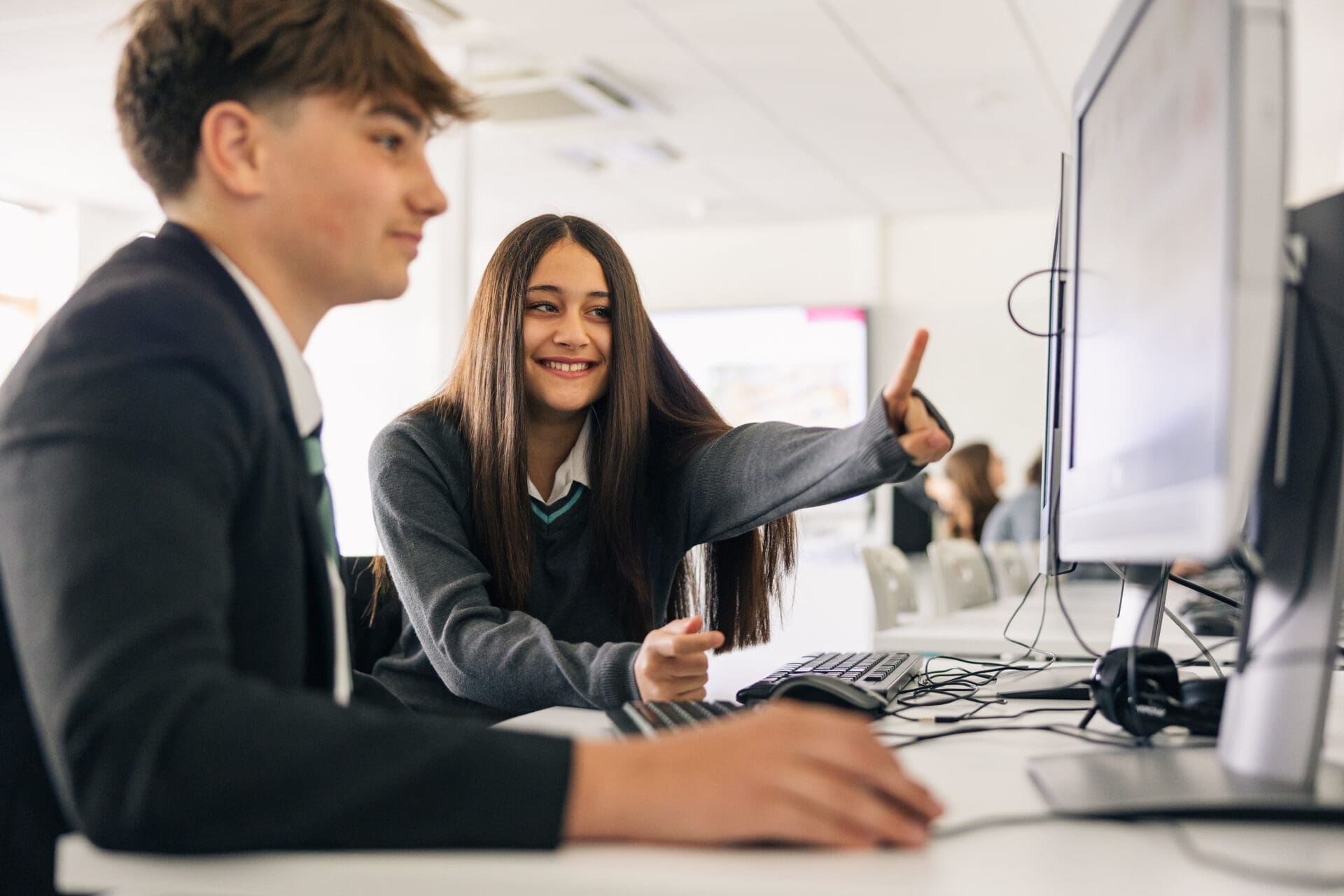 Image of 2 pupils working at a computer screen