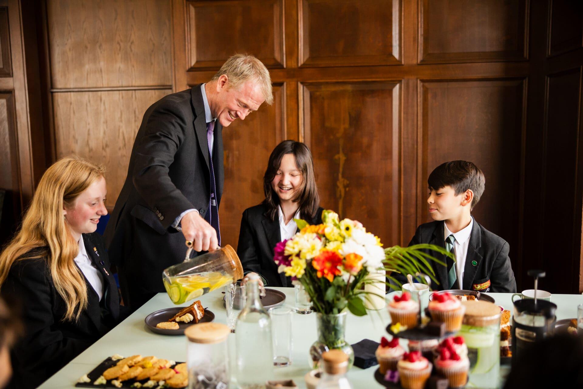 Image of the school head having afternoon teas with pupils 